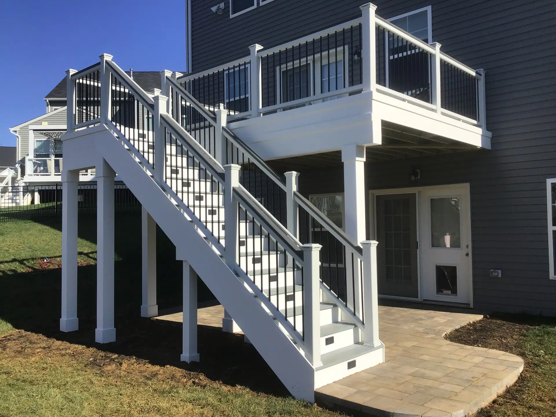 Photo of an elevated Trex deck with deck railing and deck stairs.