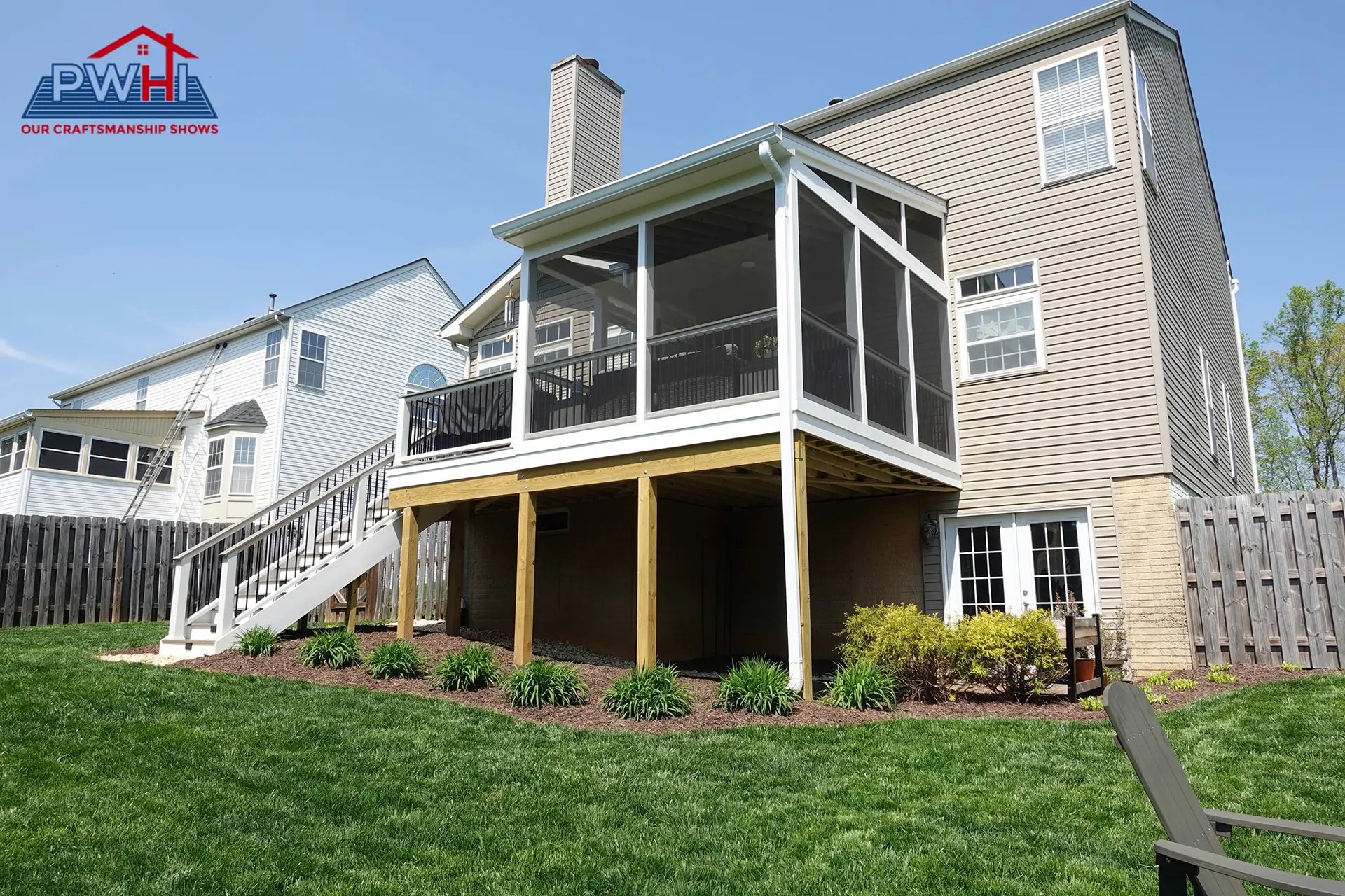 deck construction in gainesville va Raised screened porch with white framing, black railings, exterior stairs, and an open area beneath overlooking a landscaped backyard.