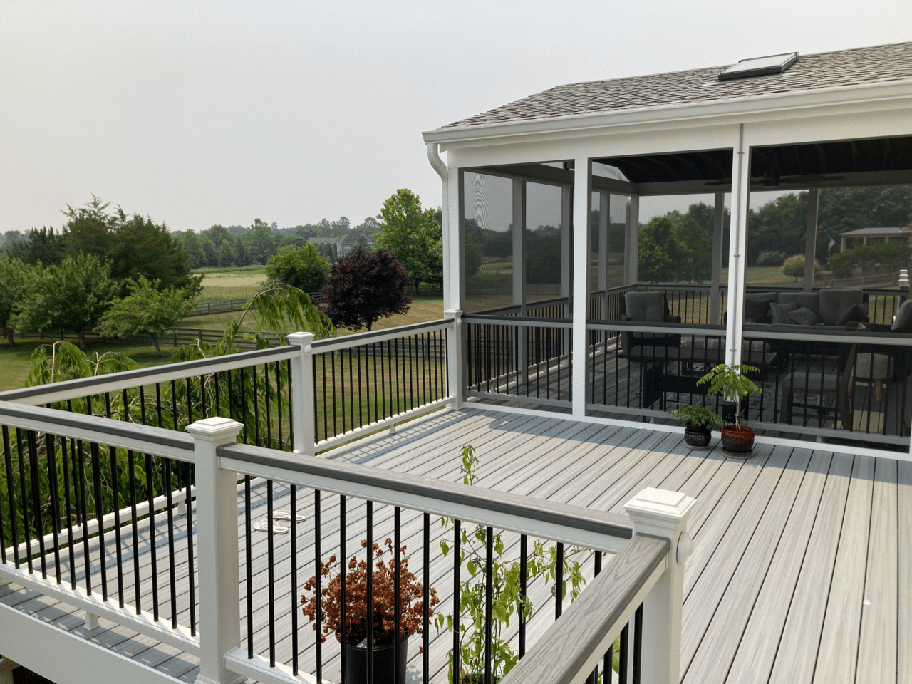 composite deck with a covered portion with screen room - Covered deck builders in Virginia