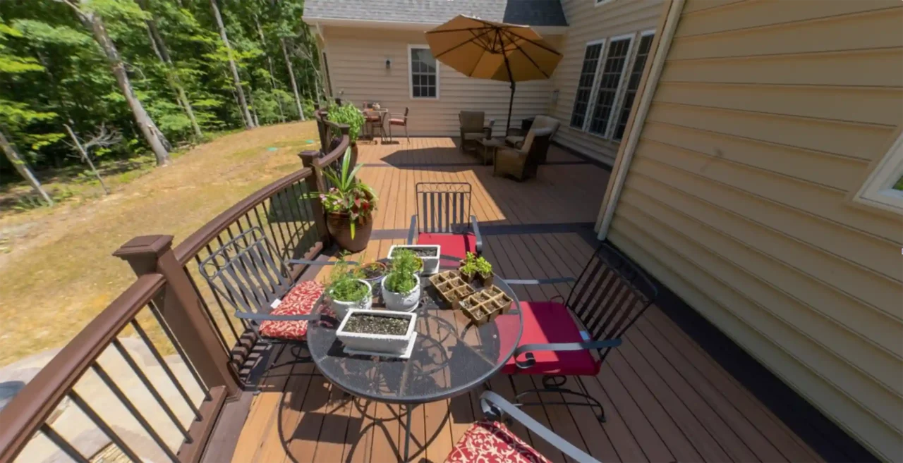 photo of a curved deck that is elevated with patio underneath and fire pit - Curved decks vs traditional decks