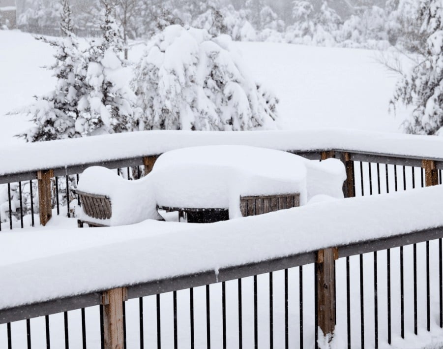 photo of a deck with snow piling high - Best Materials for Building a Winter-Resistant Deck - Composite Decking Contractors near me