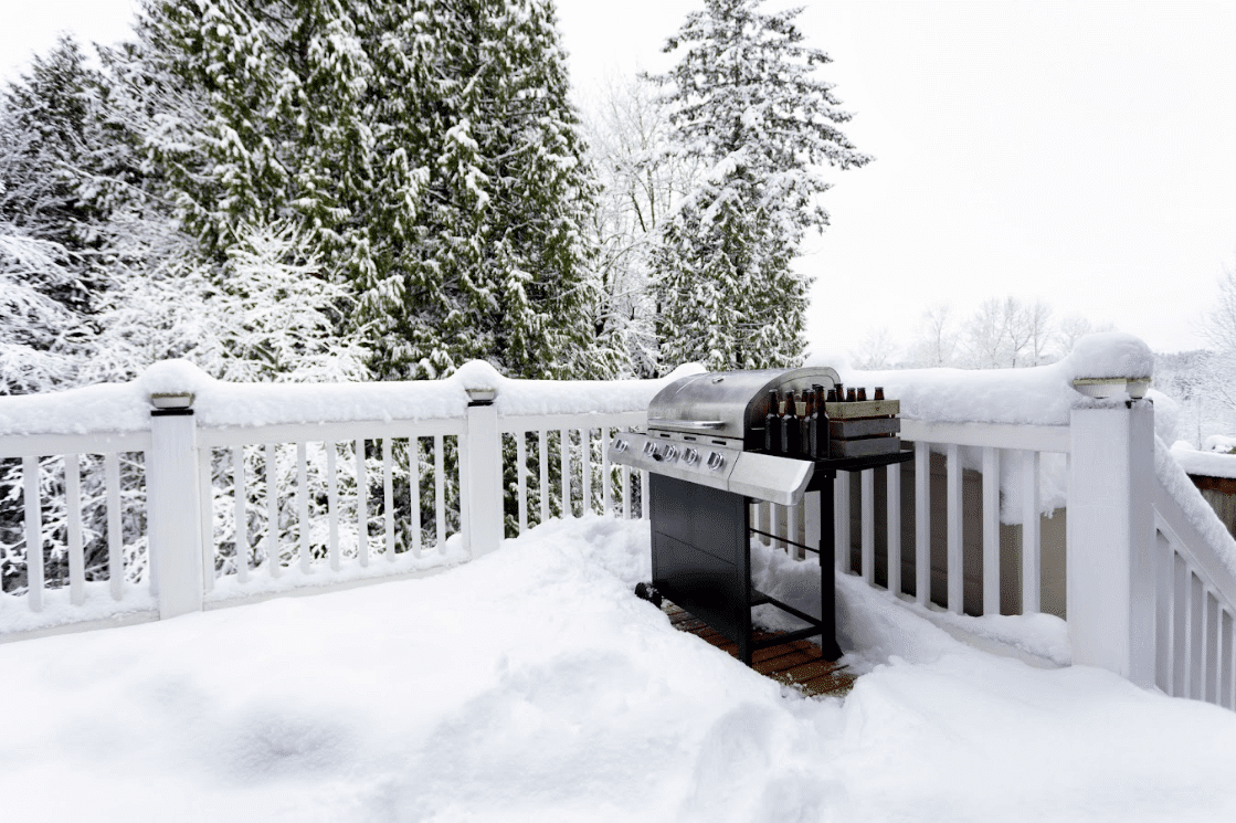 photo of a composite deck with snow piled high - Composite decking vs wood decking