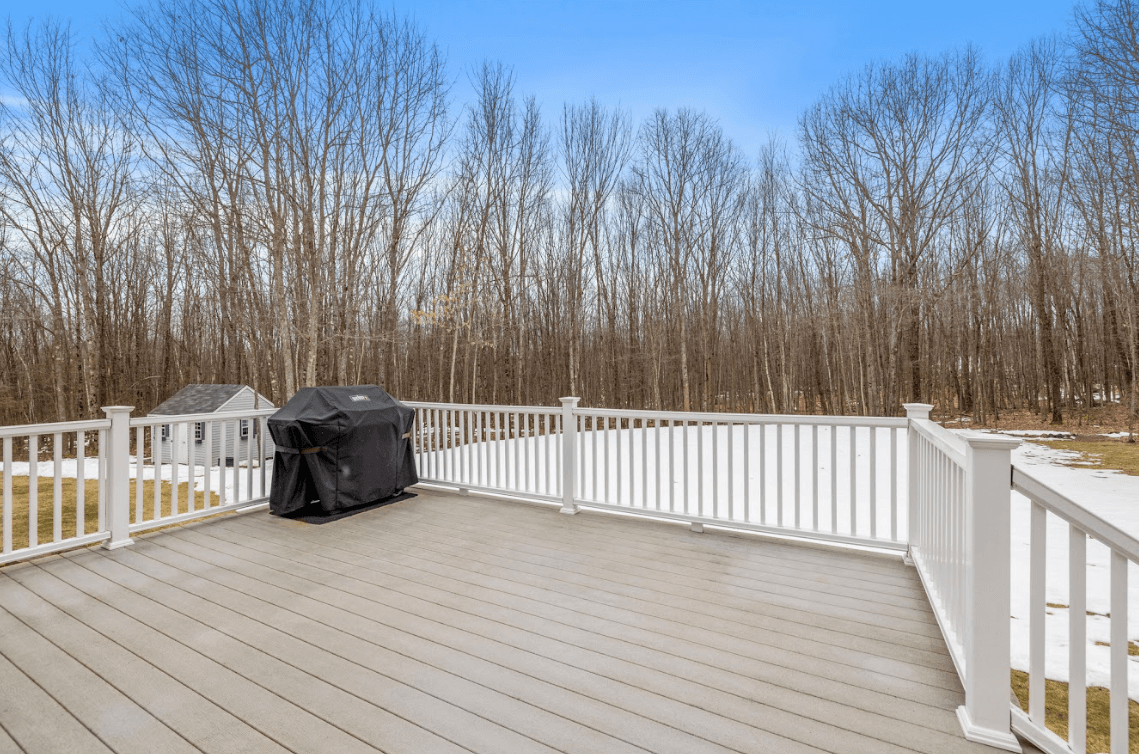 photo of a composite deck with a clear surface and snow in the yard - trex composite decking for winter - Composite decks builder and contractors in northern virginia