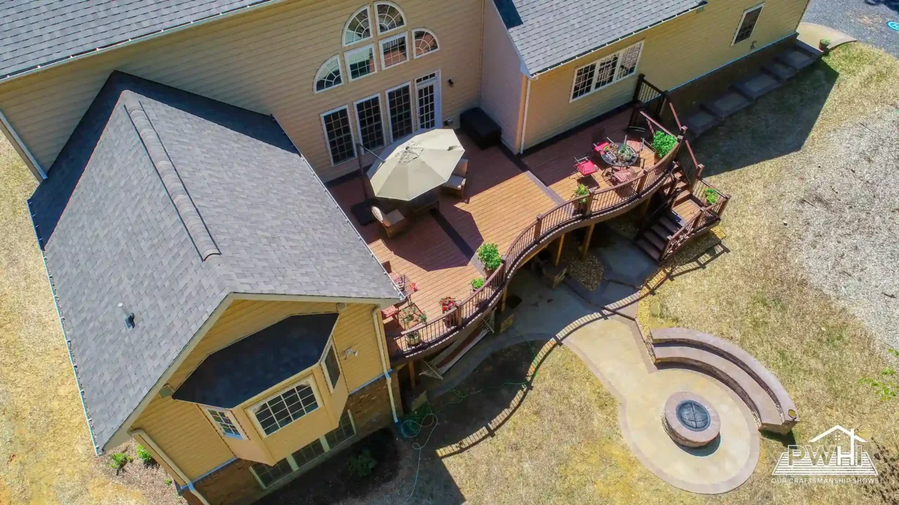 Aerial view of a deck attached to a house with a circular seating area and pathway.