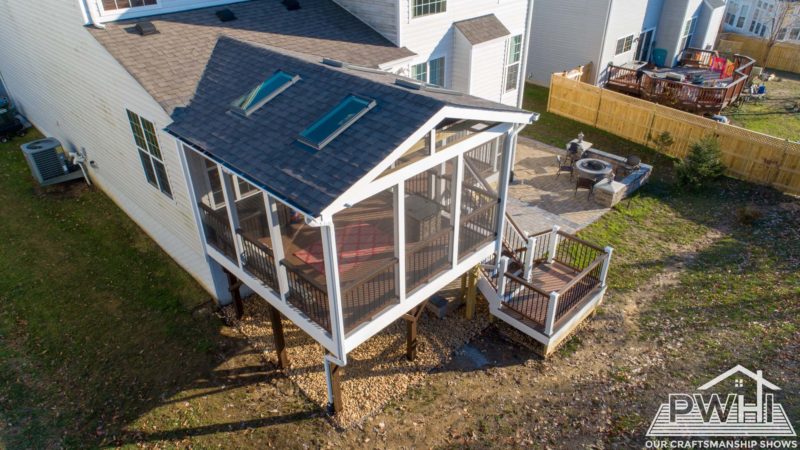 Home with outdoor sunroom aerial view