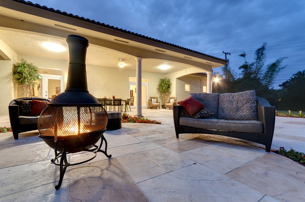 Sample Patio for Maryland outdoor living service provider Fire pit in a modern backyard with patio furniture.